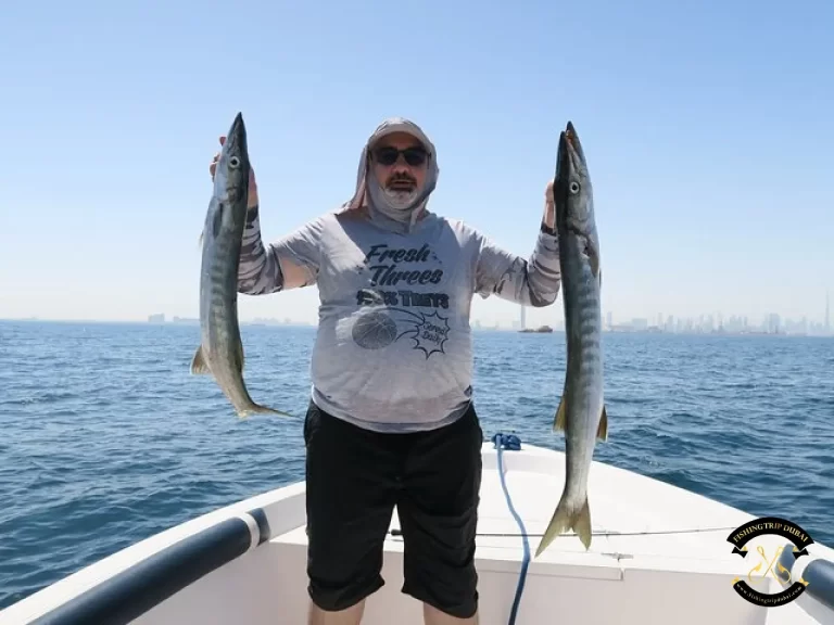 Gallery 11 A man holding two fishes on a fishing boat with fishing trip boat.