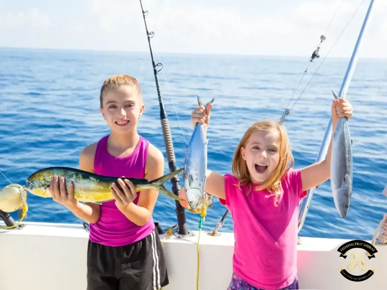 Gallery 2 two kids at the back of the fishing boat with fish in their hands.