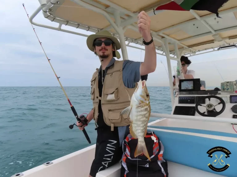 Gallery 4 A guy flexing his catch with fishing trip Dubai
