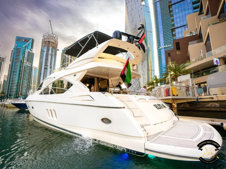 fishing trip Dubai. Sunseeker 70 ft lower side view shot exterior.