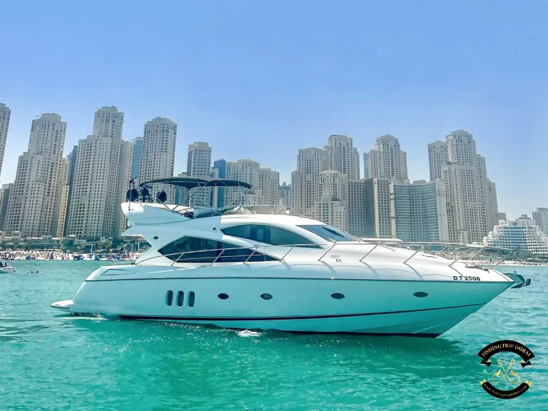fishing trip Dubai. Sunseeker 70 ft with Dubai marina at the background.